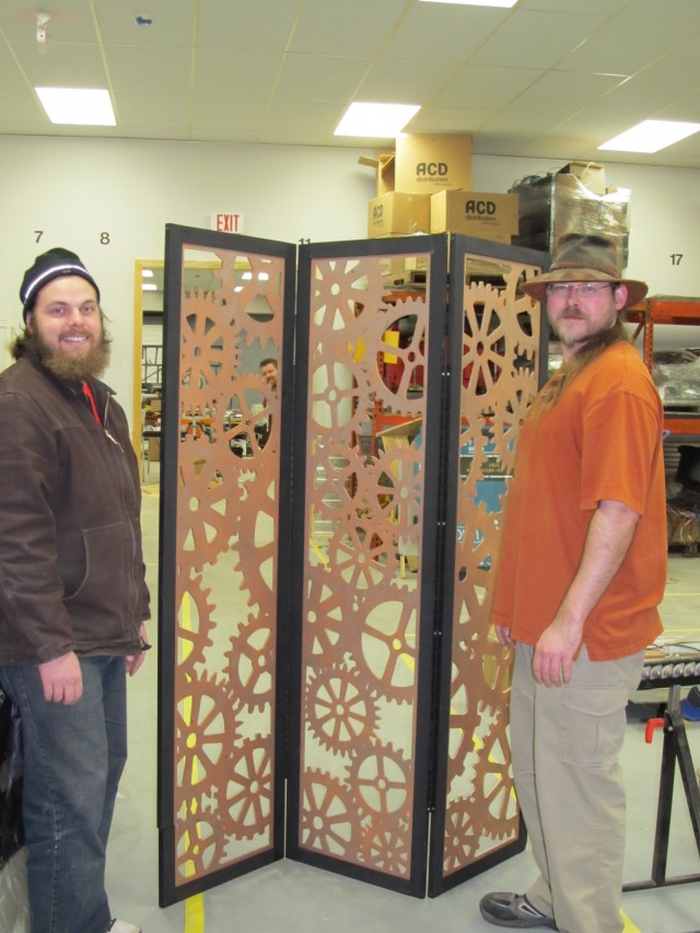 A picture of myself, Jason, and Matt, standing around the room divider