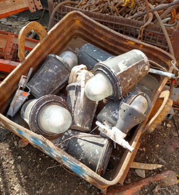 A pallet full of explosion proof lamps at the scrap yard.
